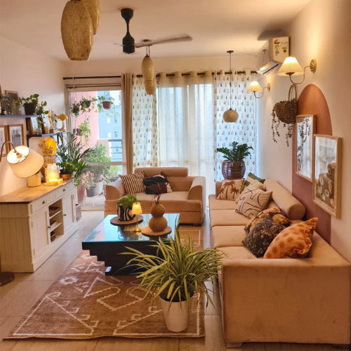 Living room with beige sofas, coffee table, and decorative items.